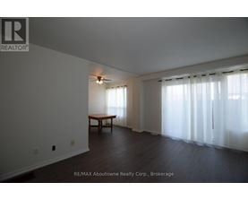 A room with a table and a window with curtains.