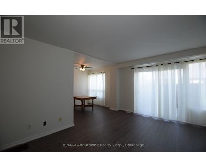 A room with a table and a window with curtains.