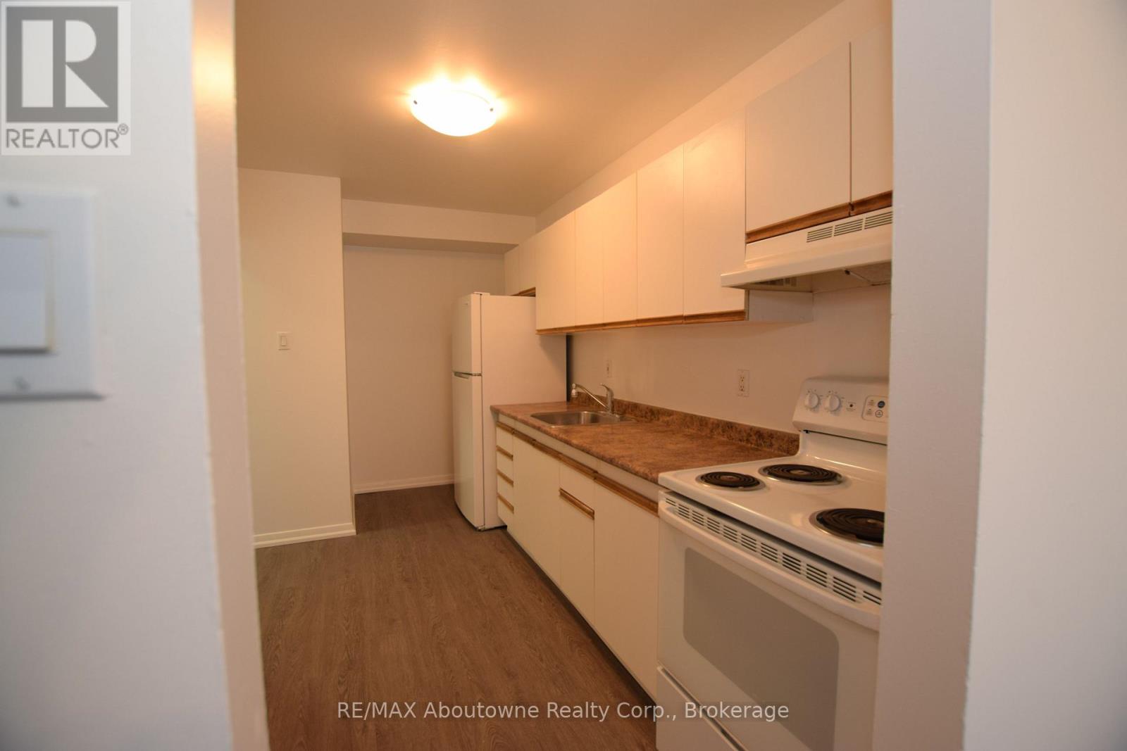 A small kitchen with a stove and cabinets.