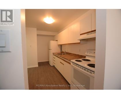A small kitchen with a stove and cabinets.