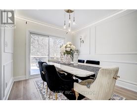 A dining room with a table set for four.