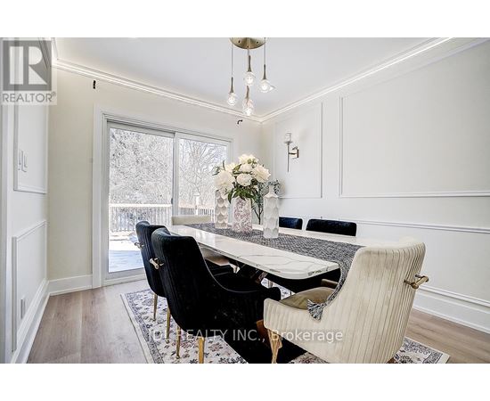 A dining room with a table set for four.