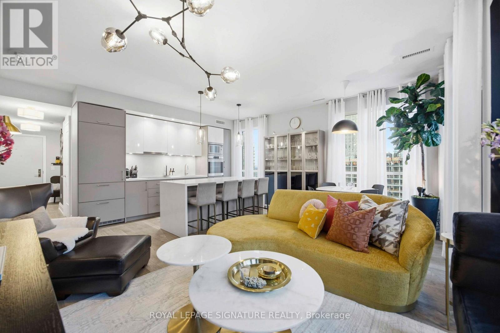 A well-lit, modern living room with a yellow sofa and a coffee table.