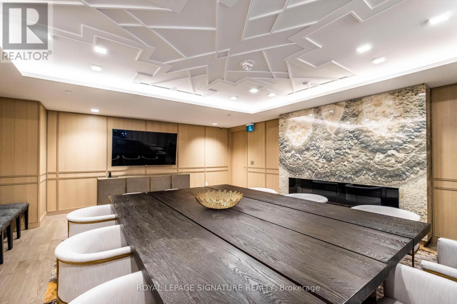 A conference room with a large table and chairs.