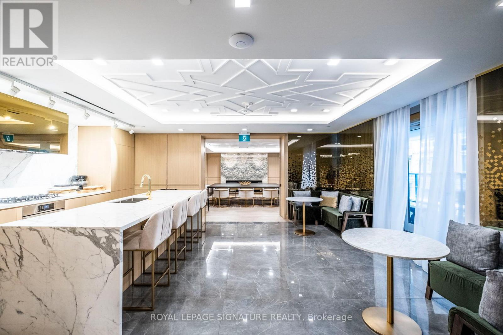A spacious dining area with a marble table and chairs.