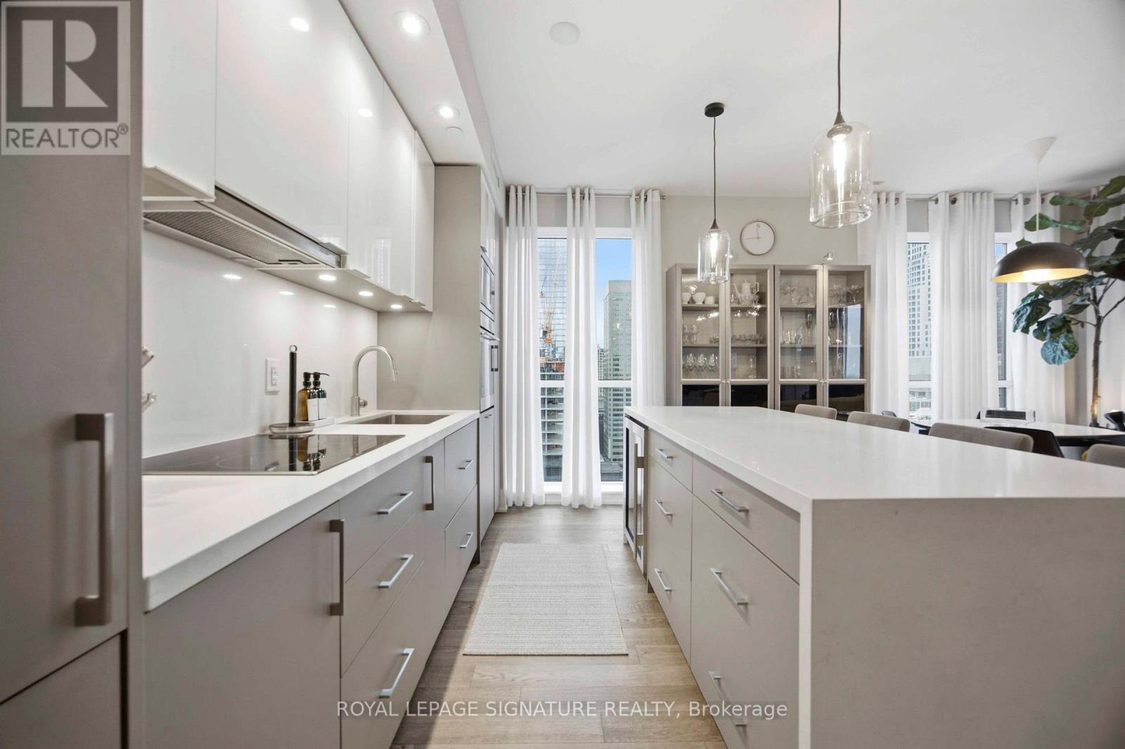 A modern kitchen with white cabinets and a large island.