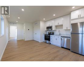 A kitchen with white cabinets and stainless steel appliances.