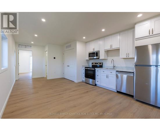 A kitchen with white cabinets and stainless steel appliances.