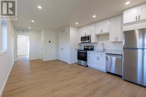 A kitchen with white cabinets and stainless steel appliances.