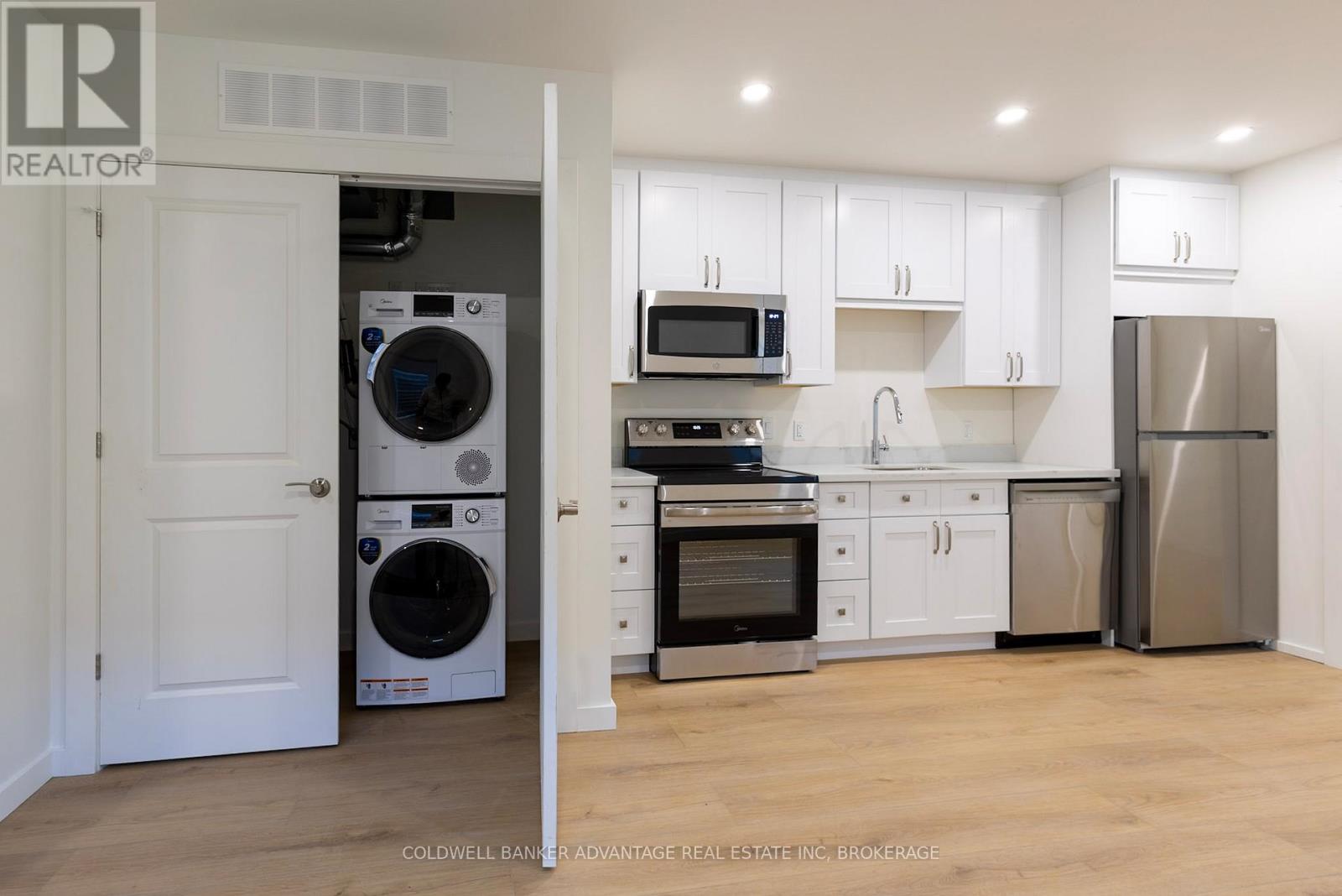 A kitchen with white cabinets and stainless steel appliances.