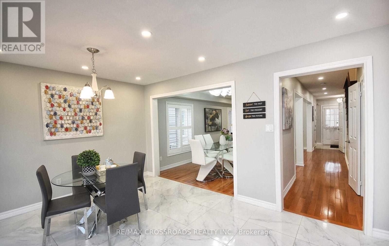 A dining room with a glass table and chairs.