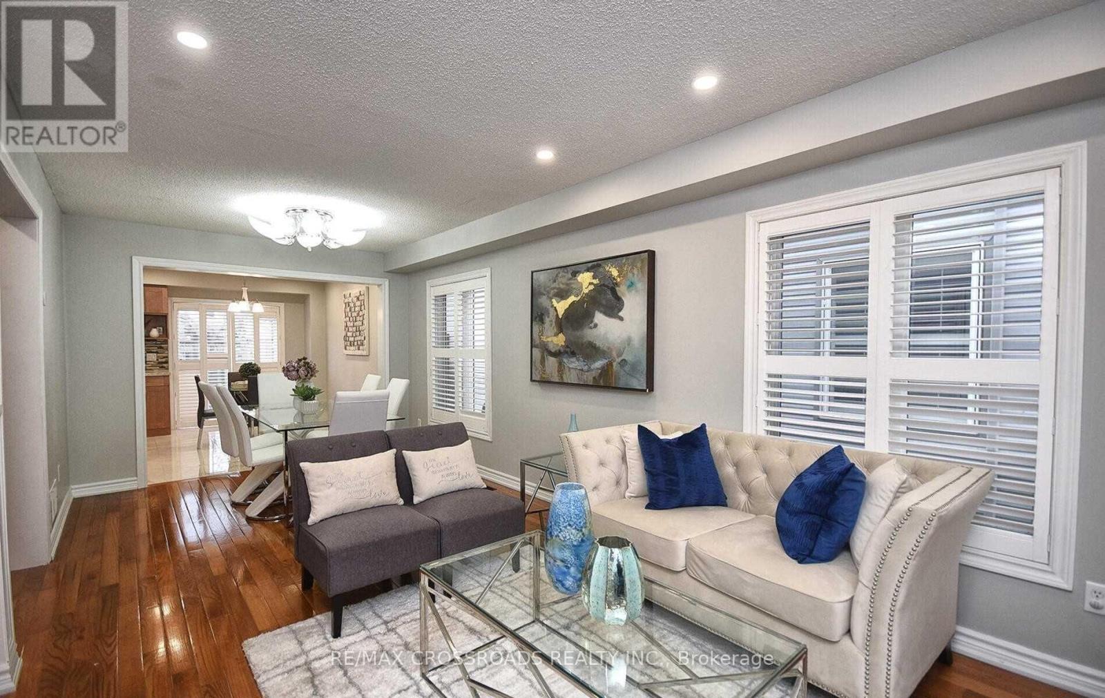 A living room with a couch, coffee table, and a painting on the wall.