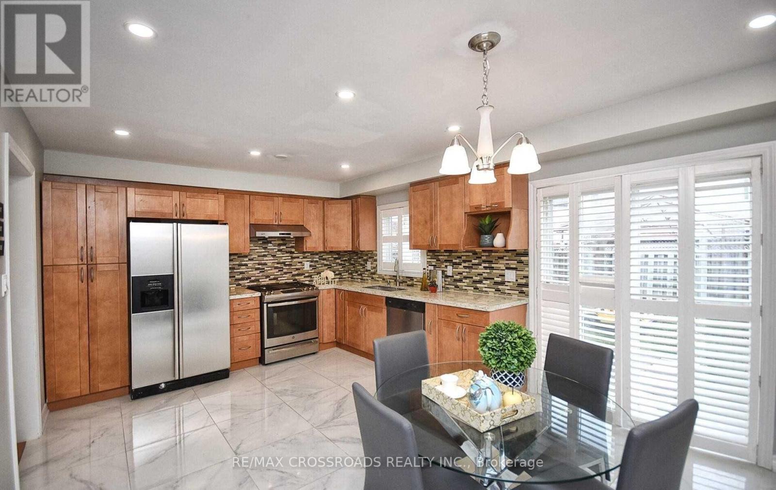 A modern kitchen with a glass table and chairs.