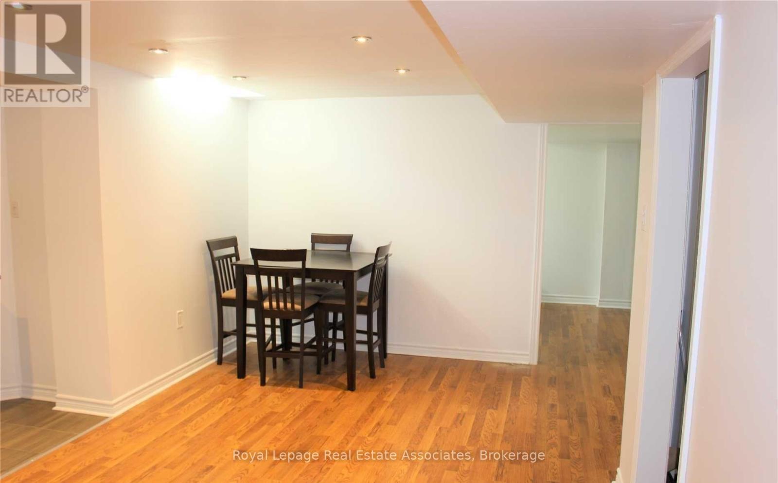 A dining room with a table and chairs.