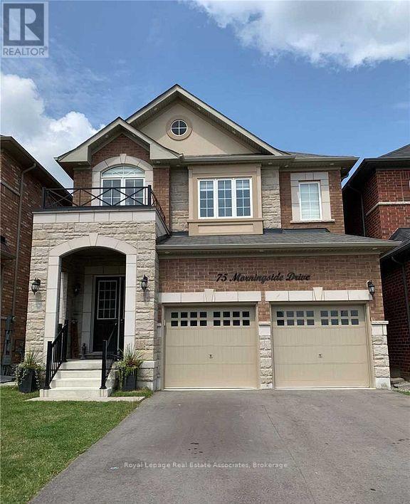A two-story house with a garage is for sale.
