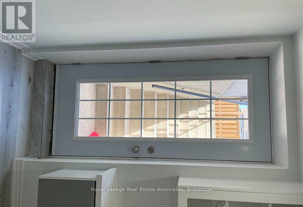 A window with a white frame and a view of a building outside.