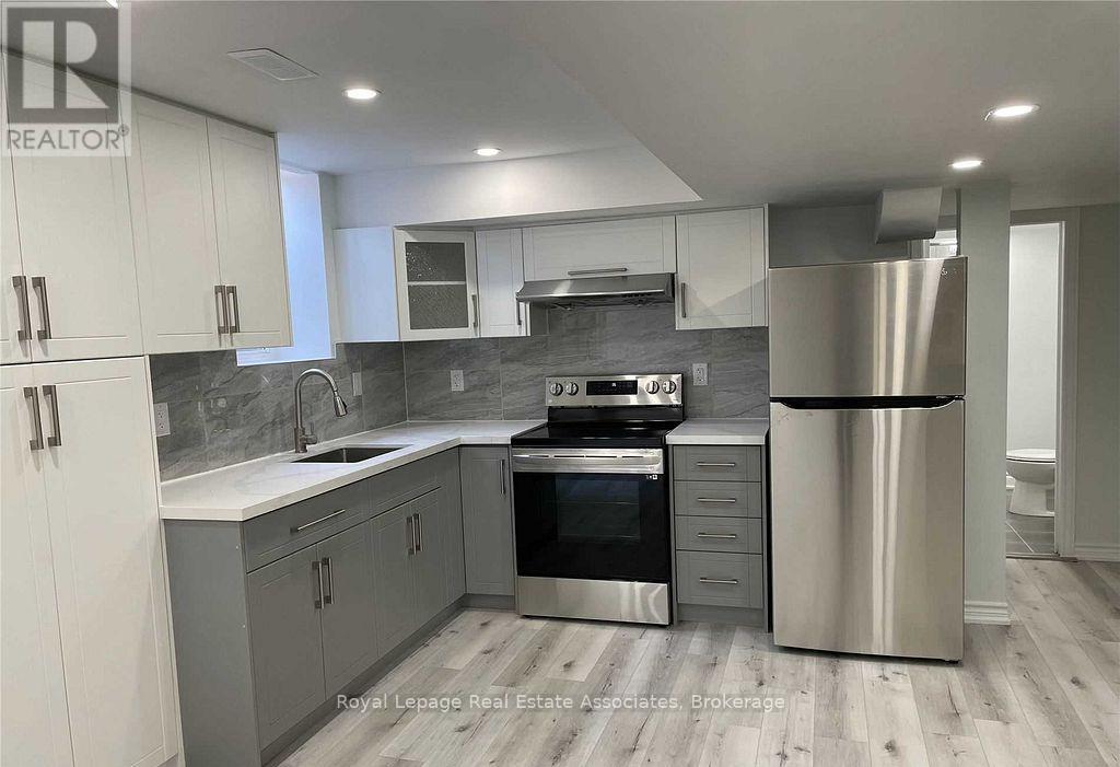 A modern kitchen with stainless steel appliances and white cabinets.