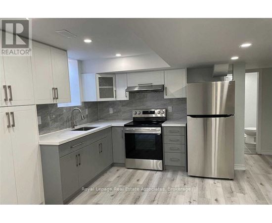 A modern kitchen with stainless steel appliances and white cabinets.