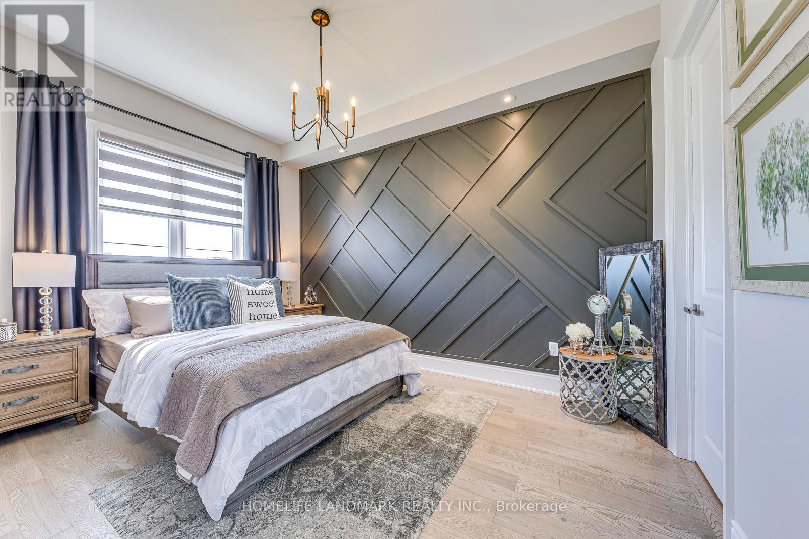 A bedroom with a large bed and a chandelier.