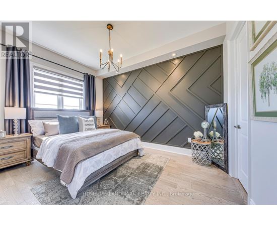 A bedroom with a large bed and a chandelier.