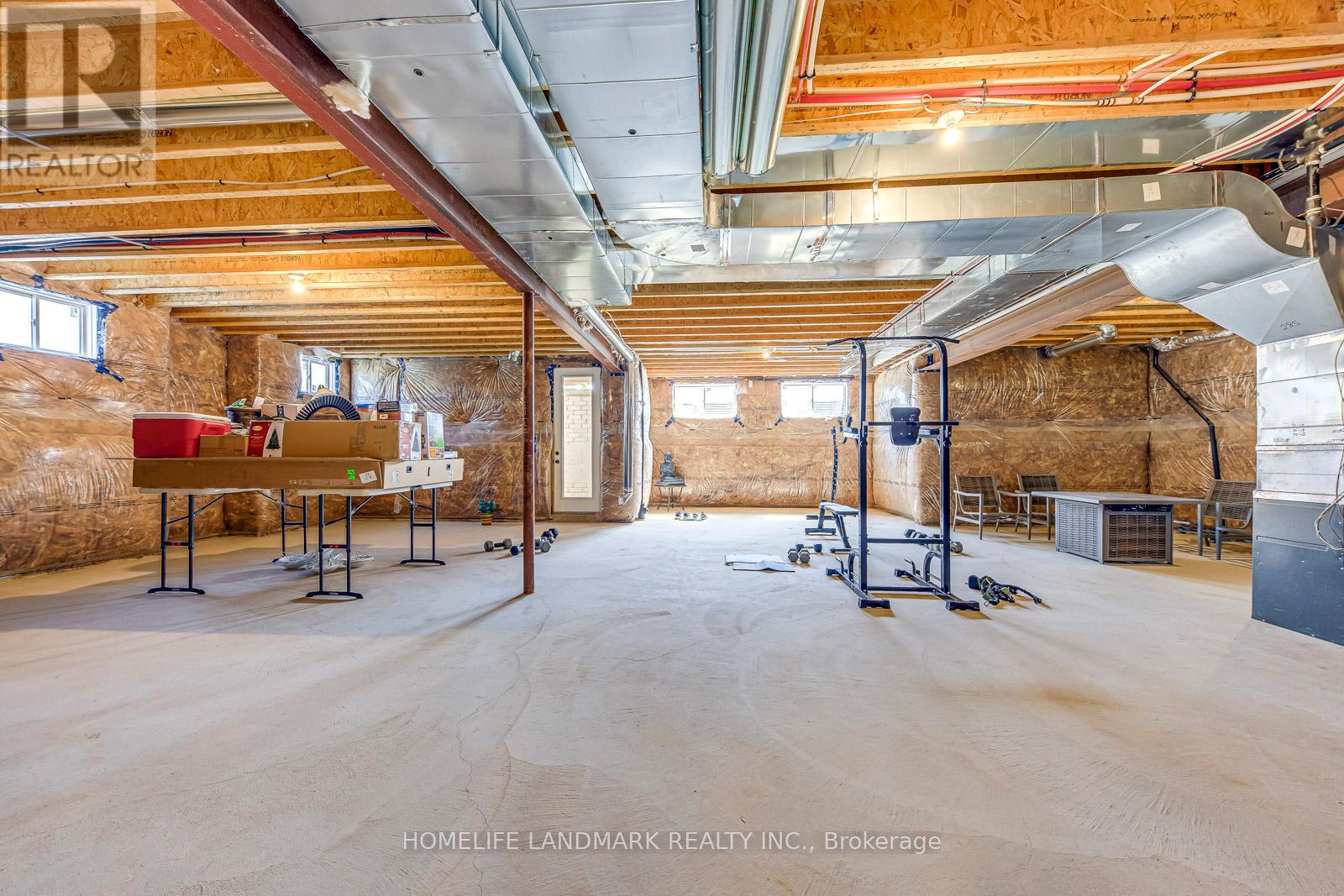 A spacious garage with a wooden ceiling and a concrete floor.