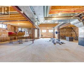 A spacious garage with a wooden ceiling and a concrete floor.
