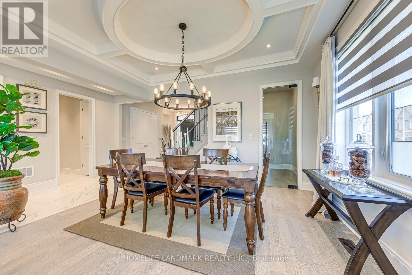 A dining room with a wooden table and chairs.