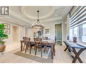 A dining room with a wooden table and chairs.