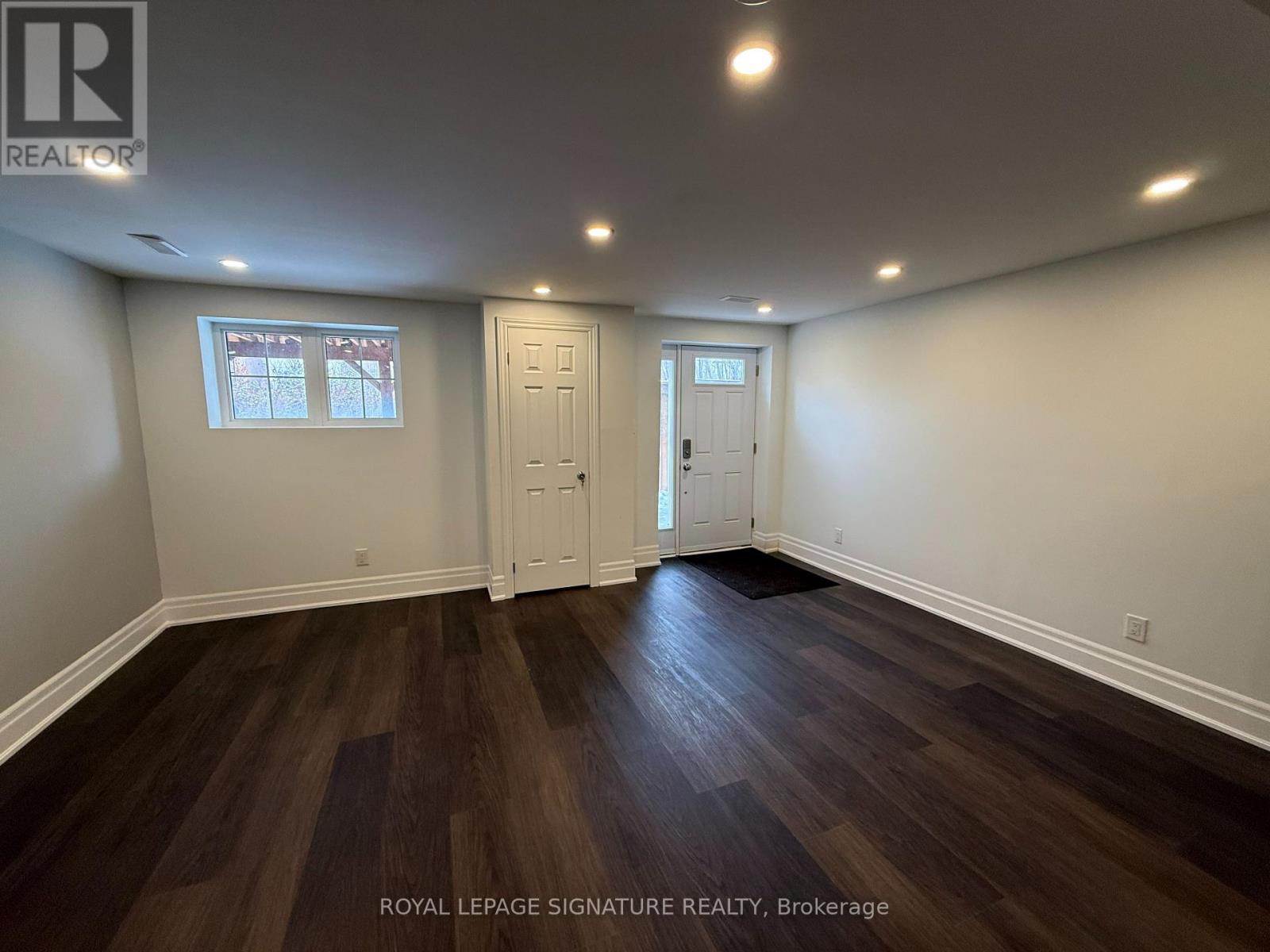A room with wooden floors and white walls.