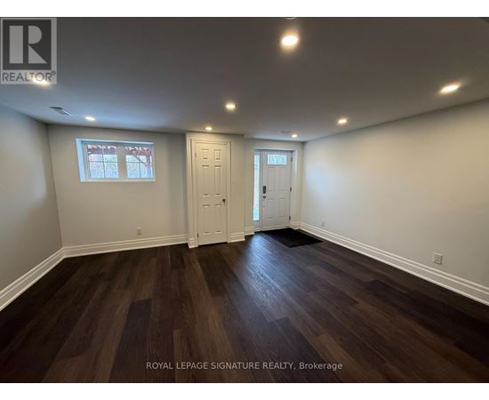 A room with wooden floors and white walls.