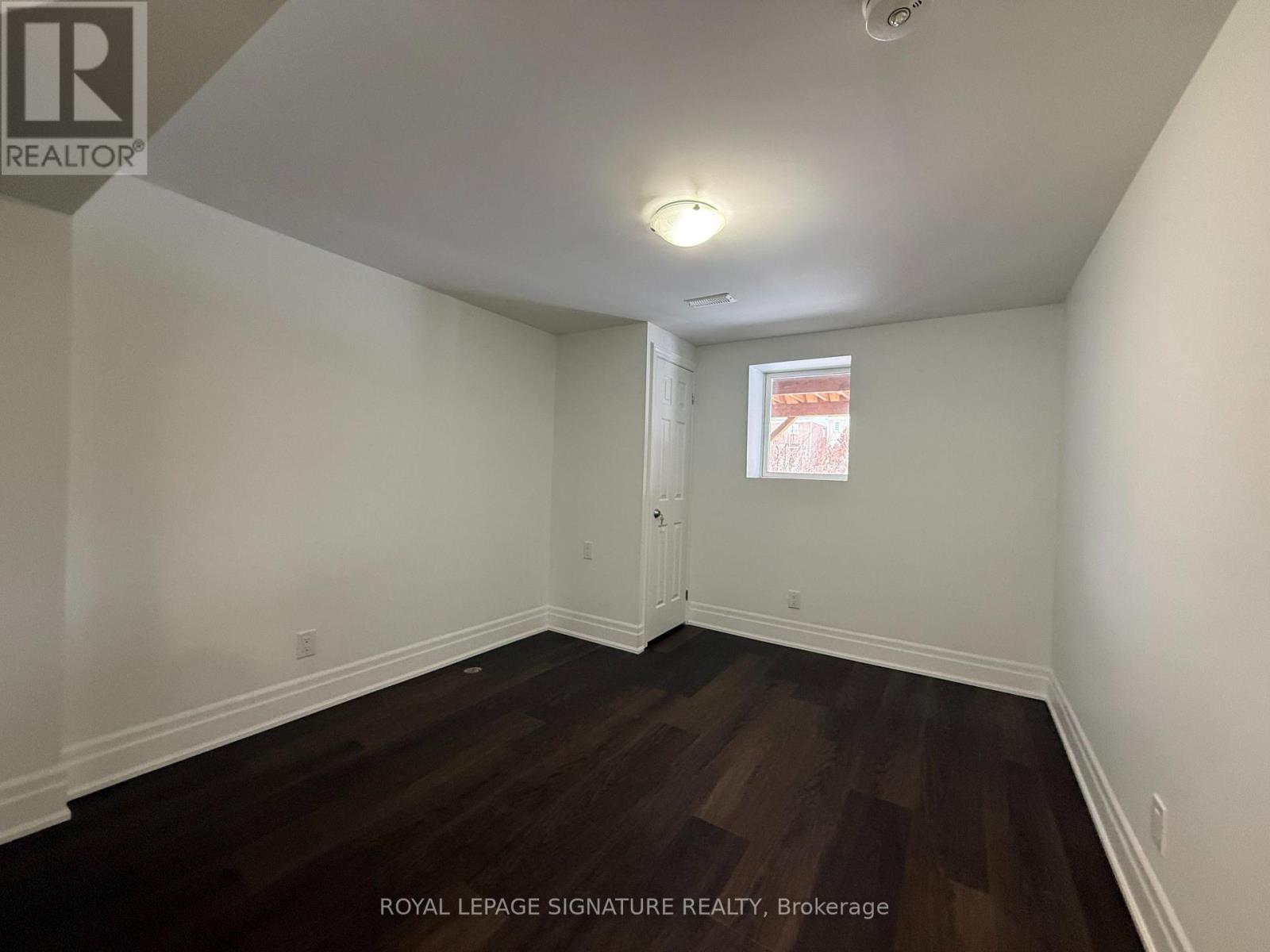 A room with wooden floors and white walls.