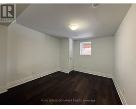A room with wooden floors and white walls.