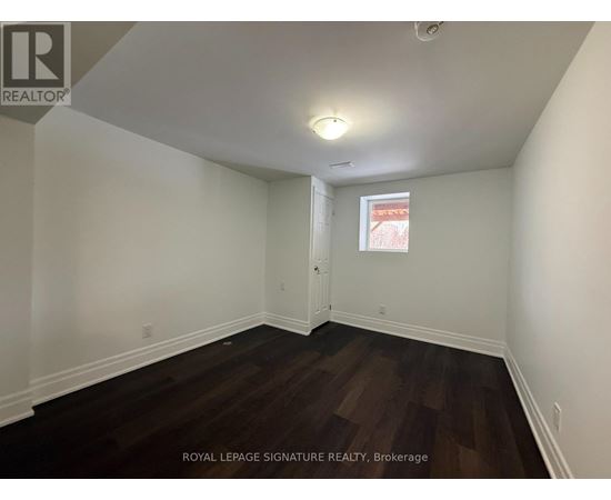A room with wooden floors and white walls.