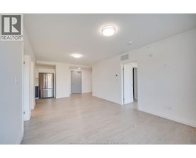 A large, empty room with a wooden floor and white walls.