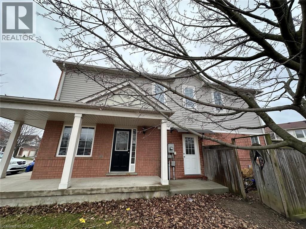 A house with a front porch and a tree in front.
