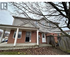 A house with a front porch and a tree in front.