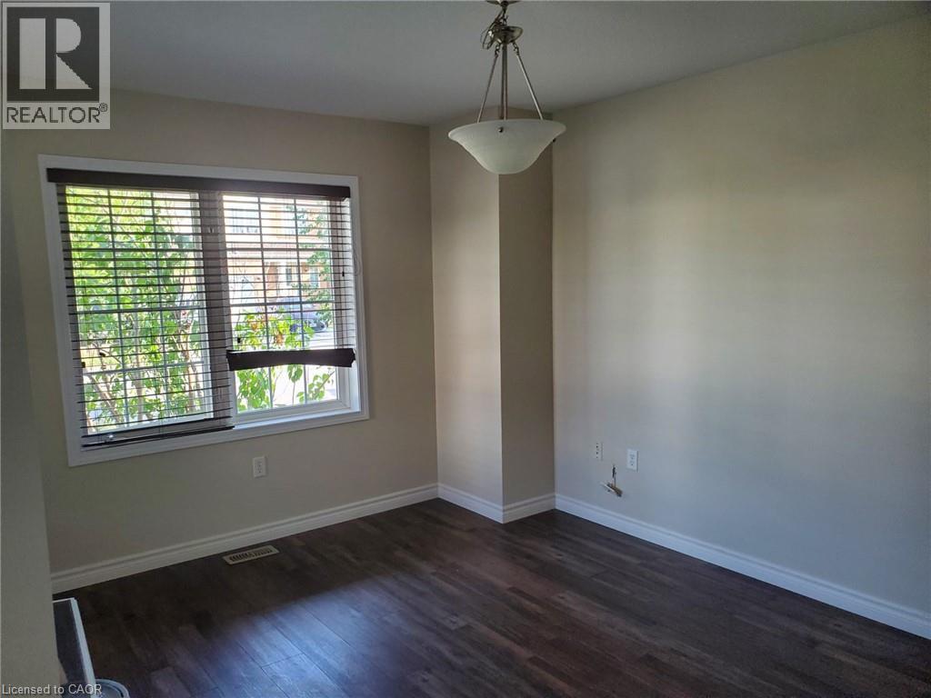 A room with a window and wooden floors.