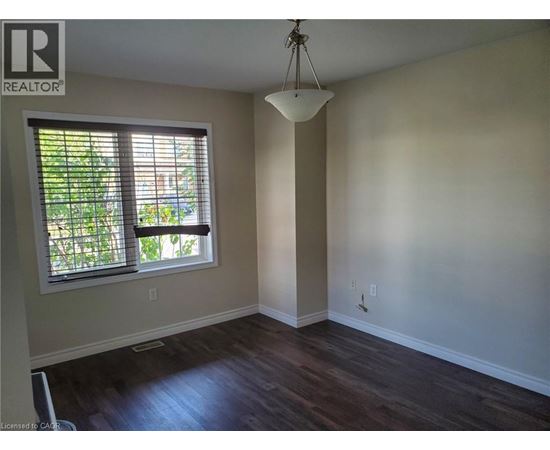 A room with a window and wooden floors.