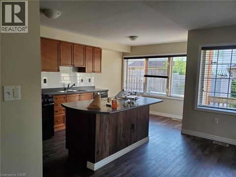 A kitchen with wooden cabinets and a large island.