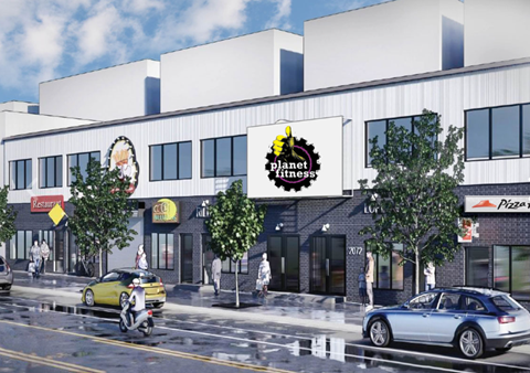 A street scene with a Planet Fitness sign on a building.
