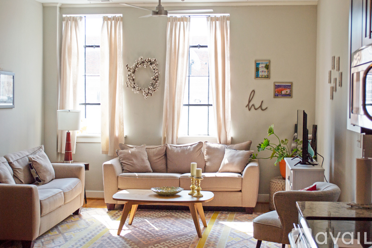 A living room with a couch, chairs, and a coffee table.