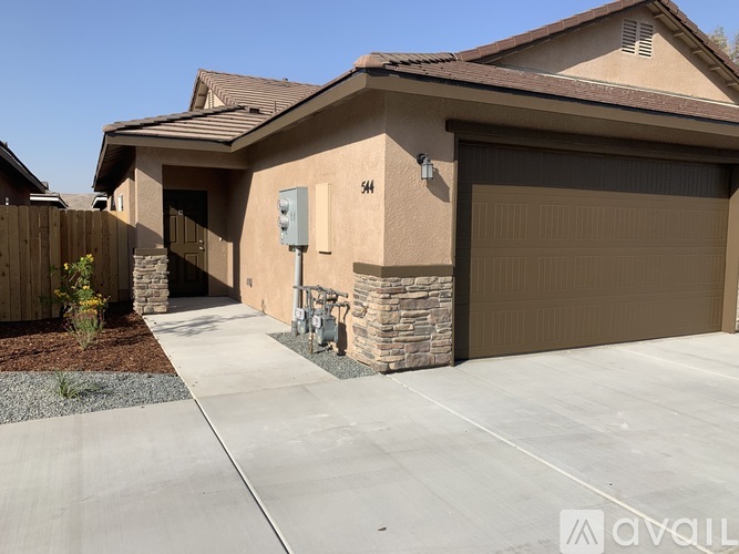 A house with a garage and a driveway.