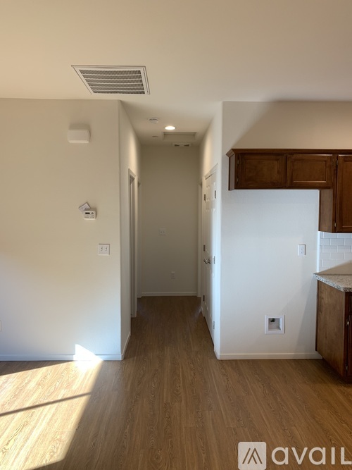 A room with wooden floors and white walls.