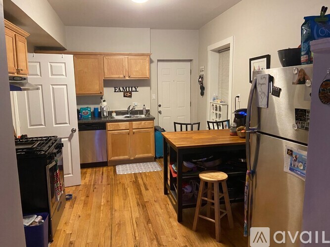 A kitchen with wooden cabinets and a refrigerator.