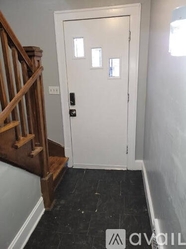 A white door with a black handle and a window above it.