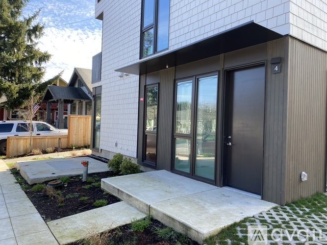 A modern house with a glass door and a number 4 on the wall.