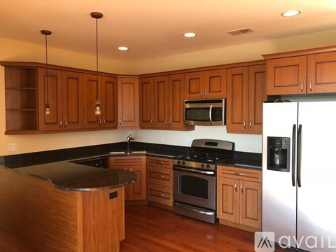 A kitchen with wooden cabinets and stainless steel appliances.