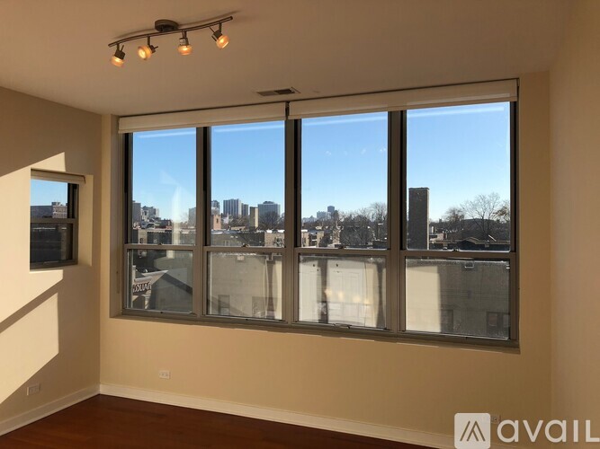 A room with a large window overlooking a cityscape.