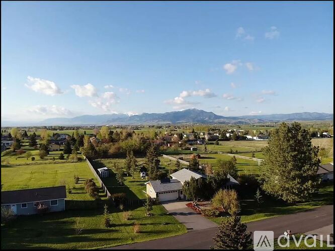 A suburban neighborhood with houses and a mountain in the distance.