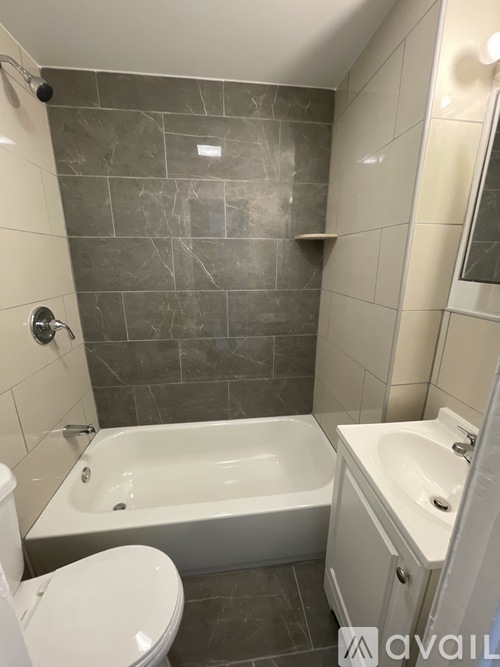 A bathroom with a white toilet, a white sink, and a white bathtub.